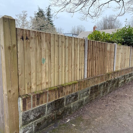 Fence behind wall